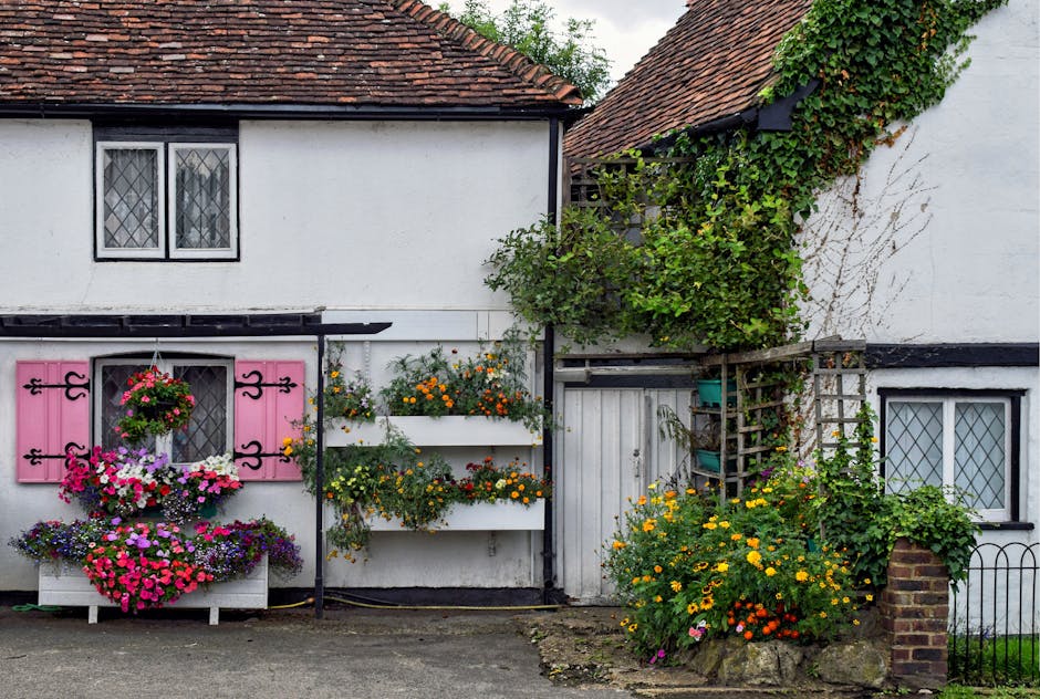 Picturesque English cottage facade adorned with colorful flowers and lush greenery in Eynsford.